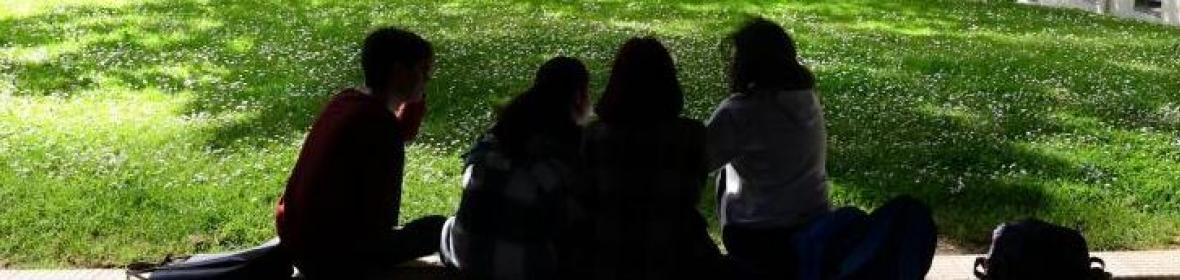 Young women sitting in the campus gardens